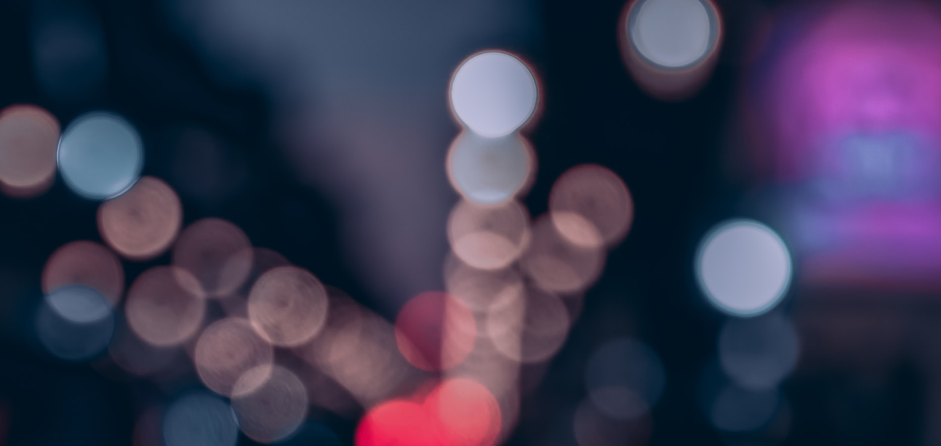 City lights blurred into pink and red bokeh after midnight